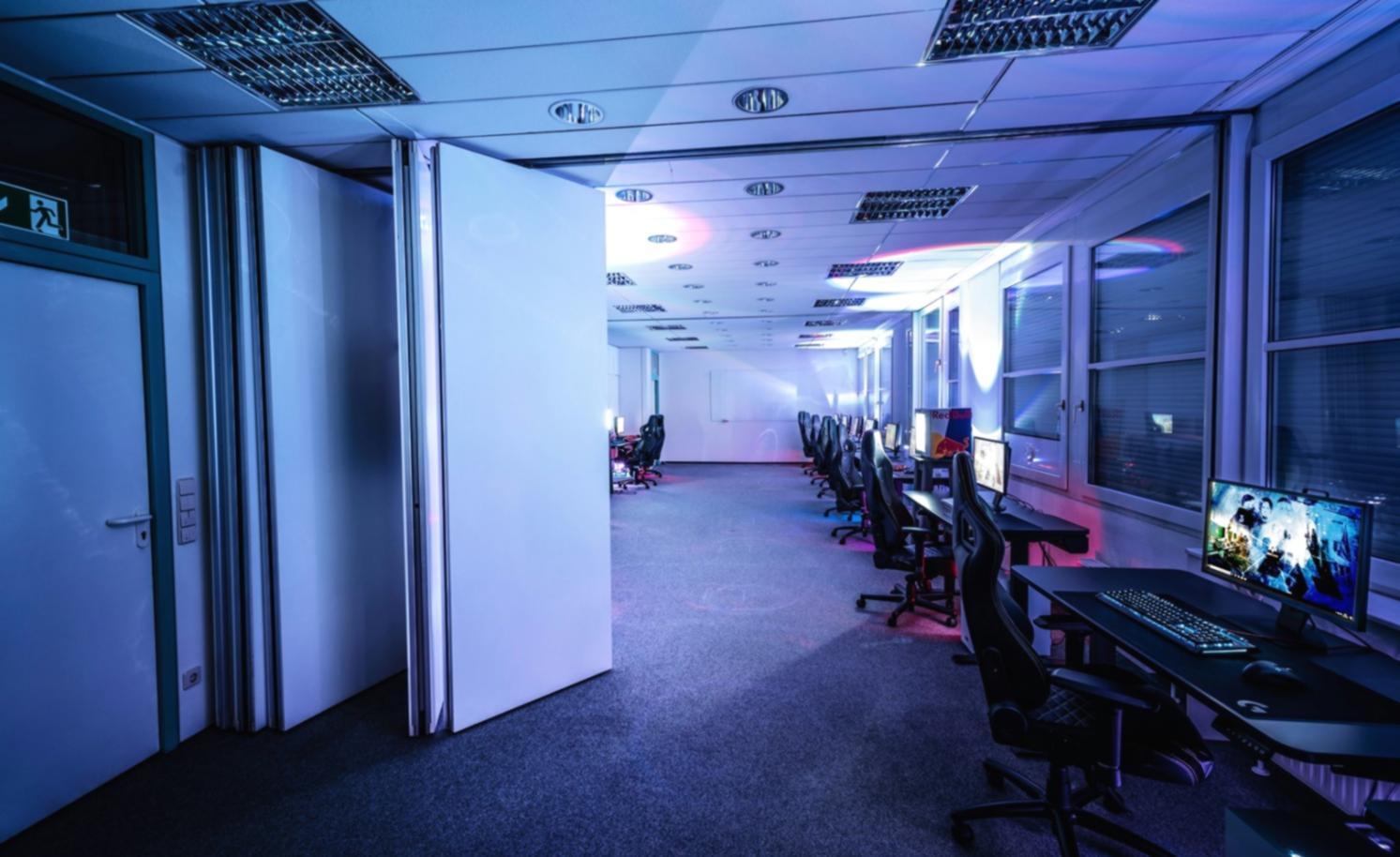 Game development workspace showing multiple screens with code editors, 3D modeling software, and game testing environments